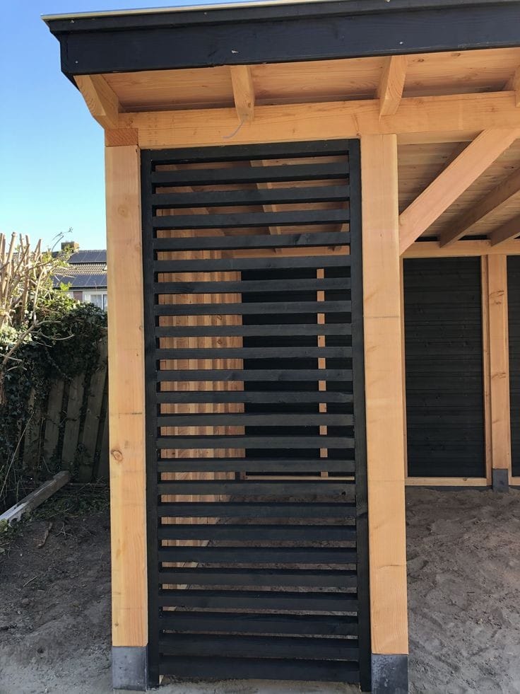 Custom cedar-framed outdoor structure with black slatted privacy screening